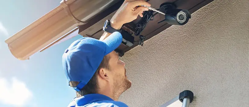 HOA security: 8 Easy Ideas To Improve Safety 3 man fixing hoa security camera