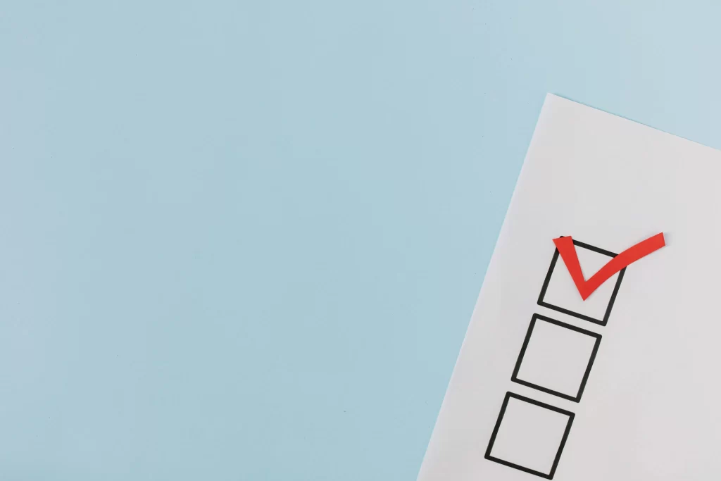 picture of a white piece of paper with a red tick in one of the three checkboxes against a light blue background to represent HOA election rules