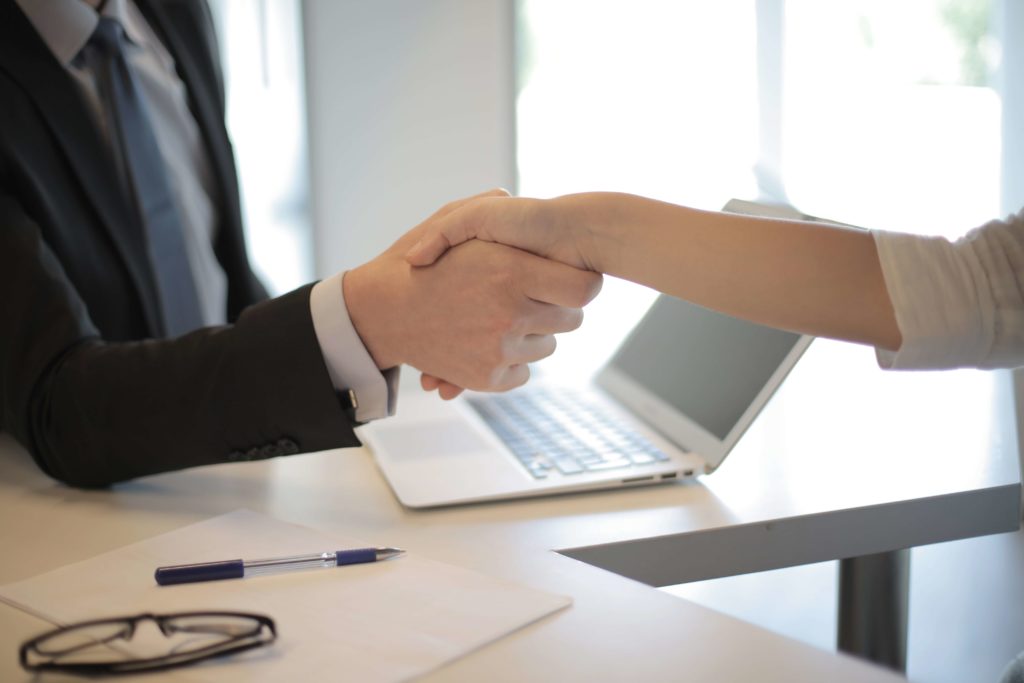 Vimteum's white-glove onboarding shaking hands