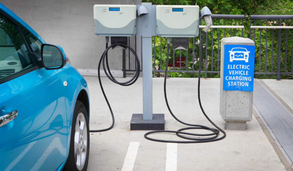 Blue car charging at an electric vehicle charging station