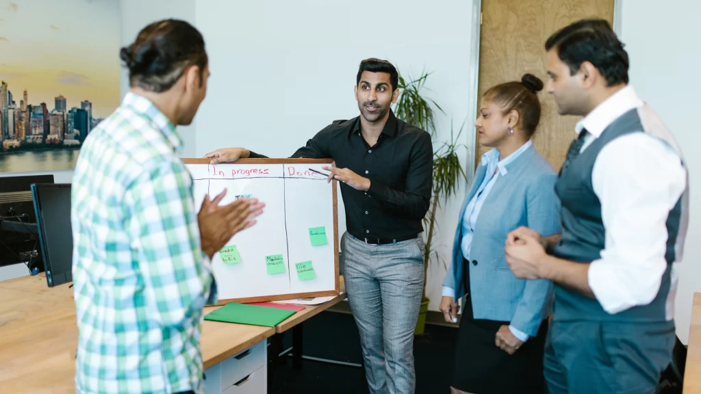 three men and one woman having a hoa meeting in an office