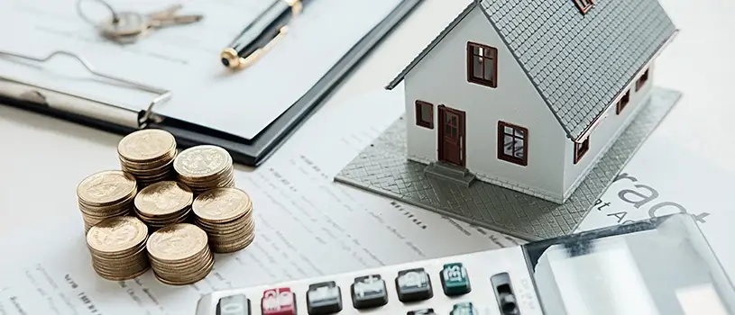 image of a house, coins and a calculator. Representing condo and HOA insurance