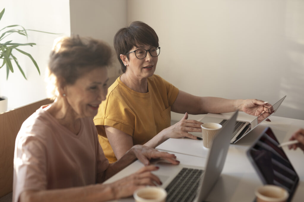 Ladies knowing how to run an hoa successfully typing on their laptops