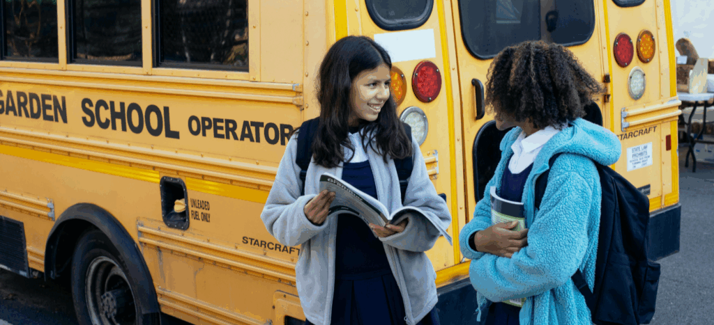 Back-to-School Season: 4 Tips to Prepare Your HOA Community 1 Back-to-School Season - Girls Waiting for the bus