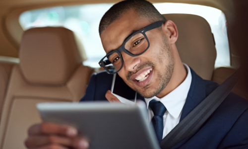 condo property manager - image of a man on the phone looking at a tablet in a car