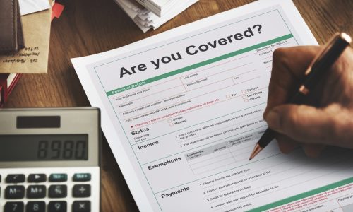 Person filling out a form for an HOA insurance in Florida, ensuring comprehensive coverage and protection for the community