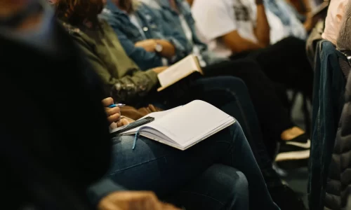 People sitting and taking notes at an HOA trade shows.